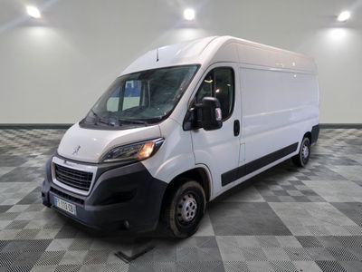 the white van is parked on a checkered tile floor