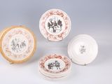 several plates with different designs and designs on them sitting on a table