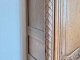 a wooden cabinet in the corner of a room