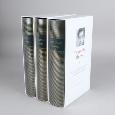 three books are stacked on top of each other on a table