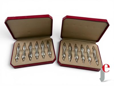 six silver spoons in a red box on a white surface