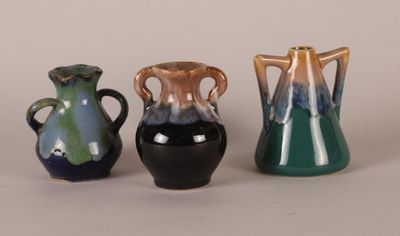 three vases sitting next to each other on a table