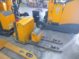 a fork lifter that is parked in a warehouse