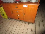 a wooden cabinet with plates on top of it