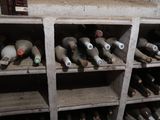 many bottles of wine sitting on the shelves in the room