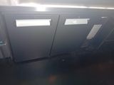 a picture of a commercial kitchen with two stainless steel refrigerators