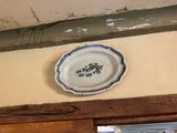 a plate on the wall above a window in a room