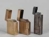 four different types of lighters are lined up on a white surface
