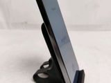 a cell phone that is on a stand on a table
