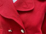a close up of a red jacket on a mannequin