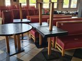 a table and chairs in a restaurant with a clock on the wall