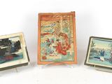 three miniature paintings of people and a train on a white surface