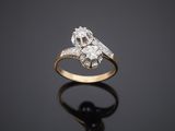 an old cut diamond ring on a reflective surface