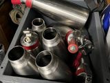 a metal box filled with cans and a can of soda