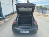a car with its trunk open on the street