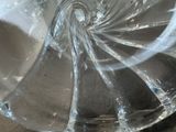 a clear glass bowl with a spiral design on it