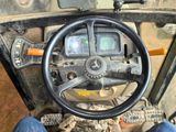 a steering wheel and dashboard of a tractor