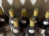 several bottles of wine are lined up on a table