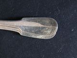 a spoon that is sitting on a black table