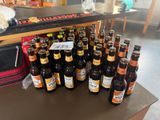 many bottles of beer sitting on a table in a room
