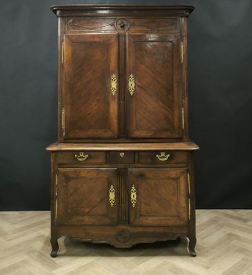 an old wooden cabinet with two doors and two drawers