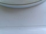 a white plate with a name on it sitting on top of a stove