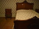 a bed with a mattress and a night stand in a room