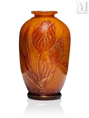 an orange vase with a floral design on it