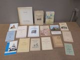 a lot of books on a table that are sitting on the table