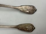 two spoons that are sitting next to each other on a table