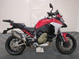 motorcycle parked in a garage with a checkered floor and a white garage door