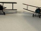 three toy airplanes that are sitting on top of a table
