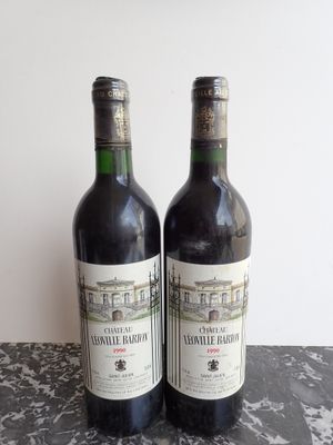 two bottles of wine sitting on top of a table next to each other