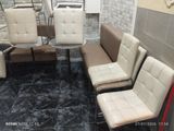 four chairs and a table in a room