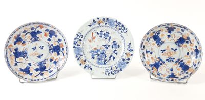 three blue and white plates with floral designs on them on a white surface