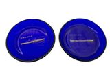 pair of blue glass plates with gold rims on a white background