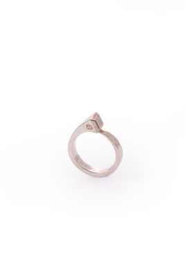 a close up of a silver ring with a diamond on it