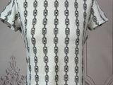 the back of a white shirt with black chains on it
