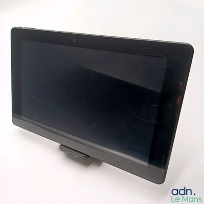 a tablet computer sitting on top of a white table