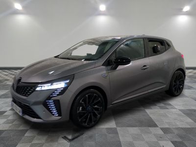 a grey car is parked in a room with checkered flooring