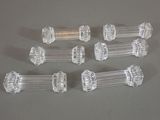 six clear glass door knobs on a gray surface
