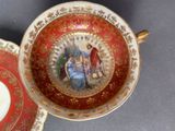 a cup and saucer with a picture of a man and a woman on it