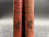 two old books sitting on top of a table next to each other