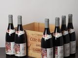 several bottles of wine sitting on a table next to a wooden crate