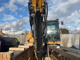 a construction vehicle that is parked on the side of the road