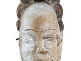 an image of a wooden mask with horns on a white background