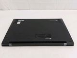 a laptop that is sitting on a white surface