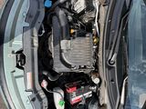 an overhead view of a car with its hood open and the engine in the trunk