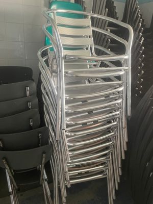 a lot of chairs that are stacked up in a room