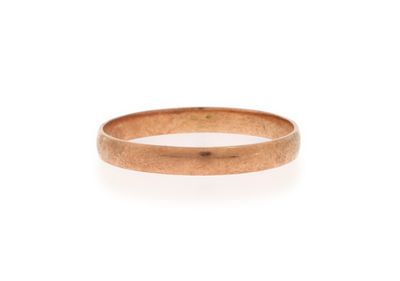 a close up of a gold ring on a white background